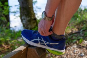 man tieing shoe lace