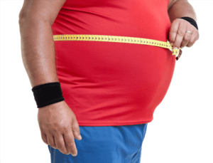 a large man holding a tape measure around their stomach