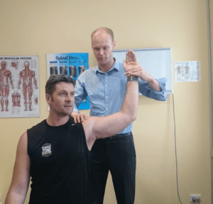 melbourne city chiropractor dr nicholas shannon assessing a patients shoulder