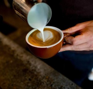 person pouring a coffee