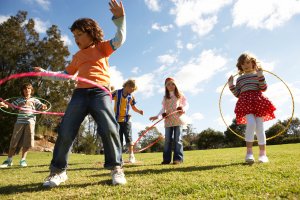 children playing with hula hoops outside