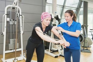 a cancer patient exercising with a physiotherapist