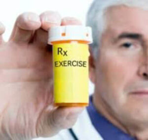 doctor holding pill box with exercise prescribed