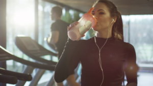 image: female drinking protein shake