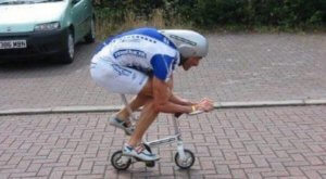 image: man riding a very small bicycle