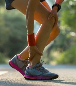 image: runner bending over holding achilles