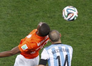 photo:two soccer players hitting head as they jump to head a ball