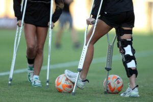 two injured female soccer players using scrutches