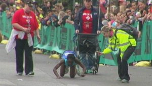 runner crawling on crowd with 3 medical support team by them