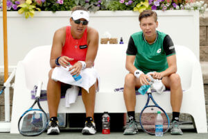 two female doubles players sitting down