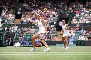 tennis players nicole melichar-martinex and kveta peschke celebrating winning a point