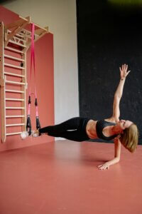 lady balancing on gym cables